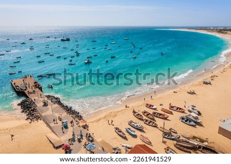 Pier and boats on turquoise water in city of Santa Maria, Sal, Cape Verde Royalty-Free Stock Photo #2261941529