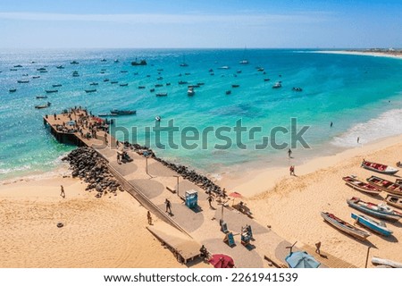 Pier and boats on turquoise water in city of Santa Maria, Sal, Cape Verde Royalty-Free Stock Photo #2261941539