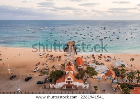 Pier and boats on turquoise water in city of Santa Maria, Sal, Cape Verde Royalty-Free Stock Photo #2261941541