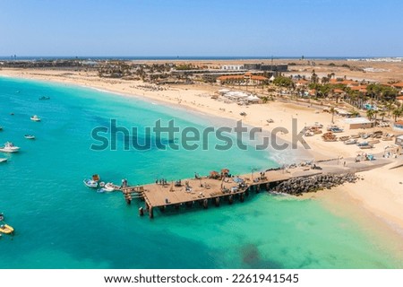 Pier and boats on turquoise water in city of Santa Maria, Sal, Cape Verde Royalty-Free Stock Photo #2261941545
