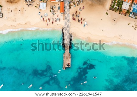 Pier and boats on turquoise water in city of Santa Maria, Sal, Cape Verde Royalty-Free Stock Photo #2261941547