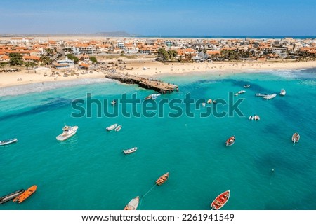 Pier and boats on turquoise water in city of Santa Maria, Sal, Cape Verde Royalty-Free Stock Photo #2261941549
