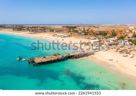 Pier and boats on turquoise water in city of Santa Maria, Sal, Cape Verde