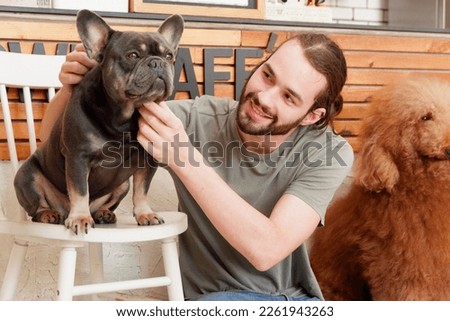 young man playing with cute dog happy smile dog love concept.