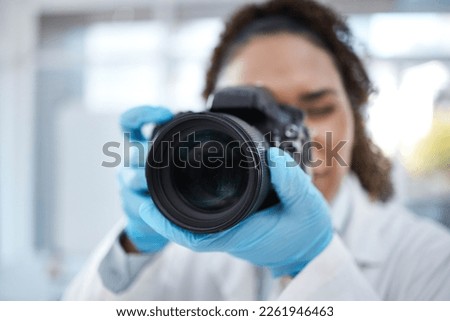 Camera, photography and lens with black woman in forensics laboratory for investigation, crime scene and evidence. Research, analytics and observation with girl and digital pictures for science