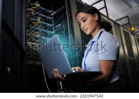 Laptop, network and data center with a black woman it support engineer working in a dark server room. Computer, cybersecurity and analytics with a female programmer problem solving or troubleshooting Royalty-Free Stock Photo #2261947543