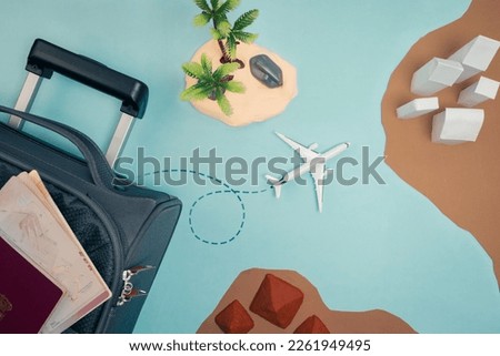 copyspace.travel map with airplane coming out of a suitcase making a travel route and around different locations, an island, pyramids, city, vacations. Royalty-Free Stock Photo #2261949495