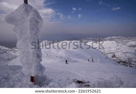 Snow covered ski pistes for skiing and snowboarding as seen from the upper cable car station, Mount Hermon Ski resort, the Golan Heights, Israel.