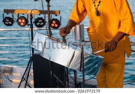 Close up of a a musician from Jamaica playing steel pan drums on the open deck of a tourist boat in Key West, Florida.	
 Royalty-Free Stock Photo #2261972179