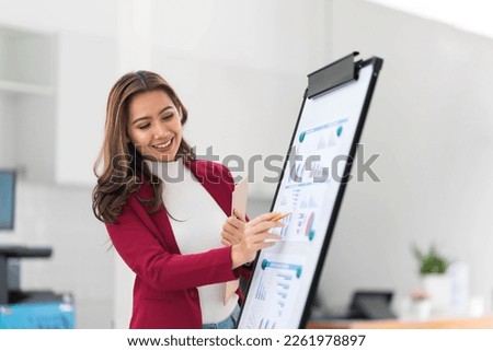 Portrait young businesswoman presentation marketing and profit with confident at office, investment and seminar for planning of finance, business woman standing explaining chart and graph. Royalty-Free Stock Photo #2261978897