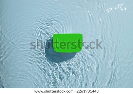 Skin care product jar surrounded by water ripples on blue background. Product mock up.
