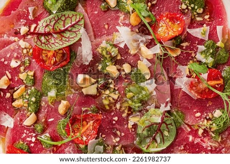  beef carpaccio with nuts and herbs