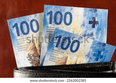 The bills slid out of the wallet. Swiss franc notes can be used as illustrations for various financial topics. CHF paper money, edition of Swiss banknotes, issued from April 2016 to 2019.
