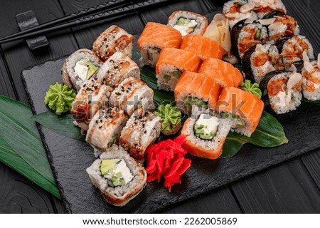 Big set of Asian food. Sushi and rolls on a dark background. Healthy food