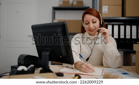Young redhead woman ecommerce call center agent having video call at office