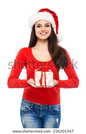 Young and attractive teenager girl with a Christmas present isolated on white background