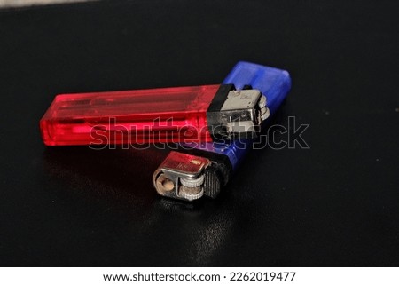 red and blue matches stacked against a black background