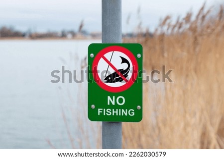 Fishing prohibited sign near lake - NO FISHING.