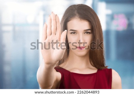 Young woman show stop sign with hand
