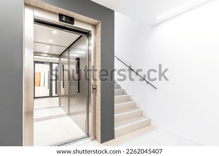 elevator and staircase in an apartment building Royalty-Free Stock Photo #2262045407