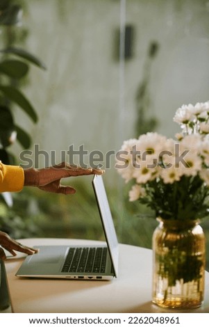 Hands of woman closing laptop after productive dat at home office