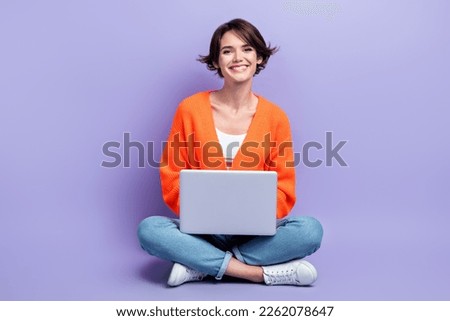 Full length size photo of young cheerful designer worker lady sitting use personal laptop enjoy her frelance job isolated on violet color background