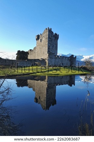 Reflection of Ross castle Killarney Ireland with snow-capped mountains in the background Royalty-Free Stock Photo #2262083687