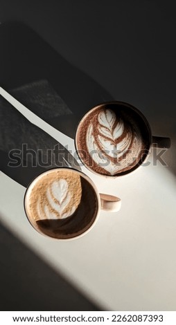 play of light and shadows wooden white table with white cups and delicious coffee with pictures on it