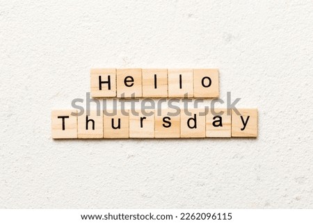 hello thursday word written on wood block. hello thursday text on cement table for your desing, concept.