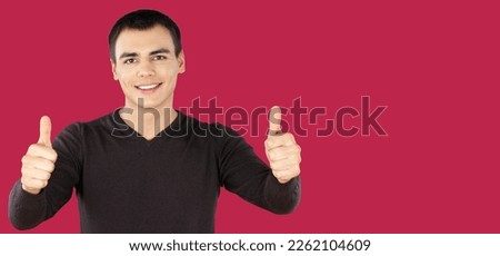 Cheerful Happy young man gesturing a sign Thumbs Up