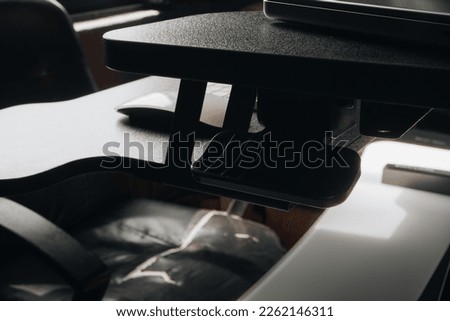 black desk for business with keyboard mouse laptop and screen