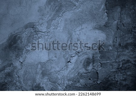 Old painted concrete wall surface. Close-up. Gray pale dusty blue color. Rough dark grunge background for design. Distressed, broken, cracked, crumbled.