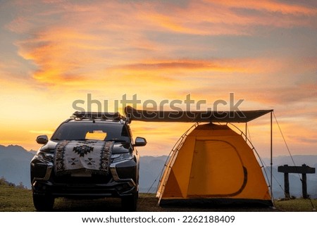 Pop up tarp building with suv car and tent on the moutain with sunset sky at chiang mai, Thailand  Royalty-Free Stock Photo #2262188409