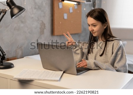 Asian girl student online learning class, study online, video call zoom teacher using laptop computer. Dormitory studying. Copy space Royalty-Free Stock Photo #2262190821