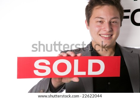 Real estate agent holding a House For Sale and Sold signs