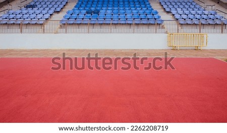 Empty space in front of spectator grandstand in sports stadium