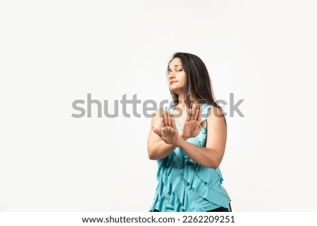 Indian woman isolated on white background rejecting someone showing a gesture of disgust.