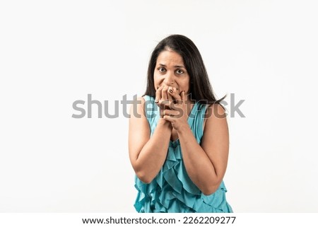 Mid aged Indian woman isolated on white background biting fingernails, nervous and very anxious.