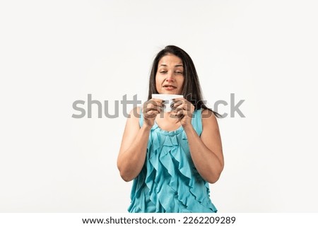 Mid aged Indian woman with tissue sneezing on white background. Runny nose Royalty-Free Stock Photo #2262209289