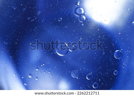 Oil bubbles close up. a circles of water macro. abstract light blue background