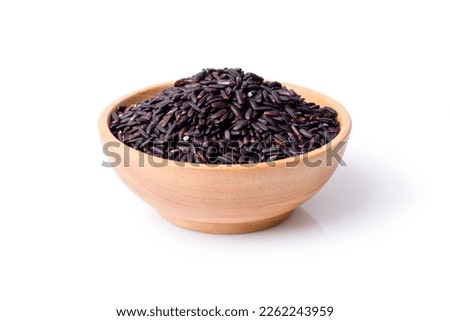 Black rice in wooden bowl isolated on white background. Clipping path. Royalty-Free Stock Photo #2262243959