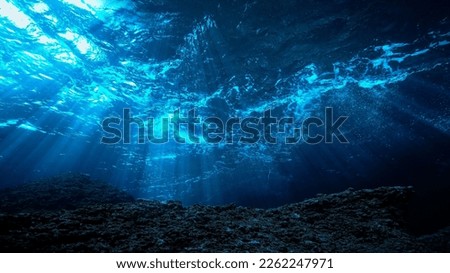 Underwater photo of rays light in the deep blue ocean. Royalty-Free Stock Photo #2262247971