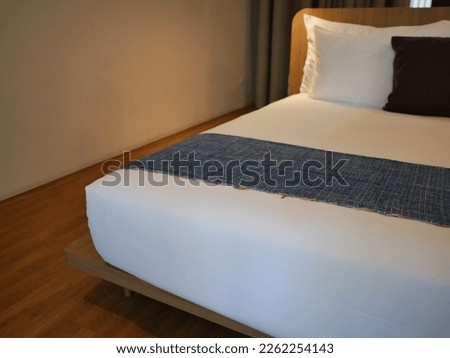 Blur focus of beautiful towel on bed decoration in bedroom.Blur focus of modern bedroom interior background.
