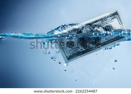 Money laundering. US Dollar banknotes in the water. Copy space. Royalty-Free Stock Photo #2262254487