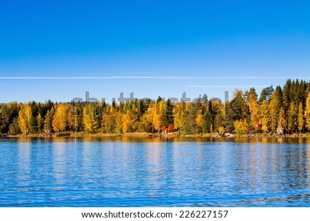 Fall colors reflected in a smooth lake