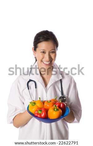 Asian woman doctor offering bowl of colored peppers