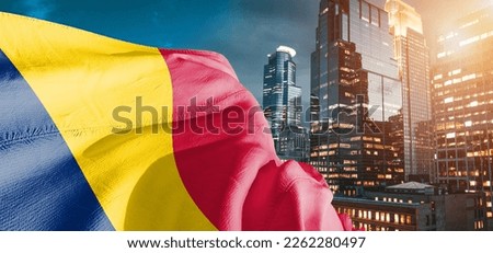 Chad national flag cloth fabric waving on beautiful buildings background.