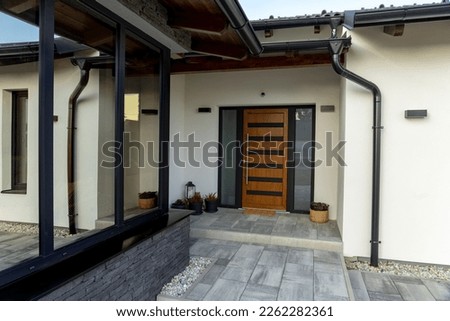 Entrance of a modern house gray wooden white