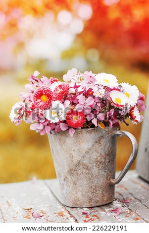 Summer bouquet of garden pink and white daisy on rustic table