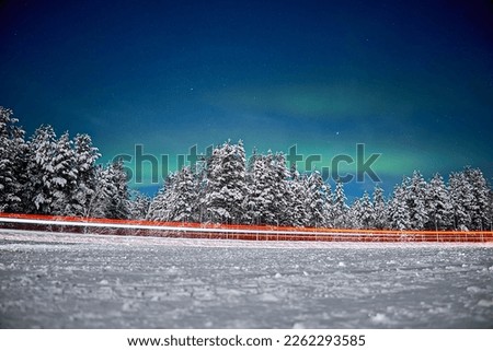 Aurora on night winter background. Winter road. High quality photo